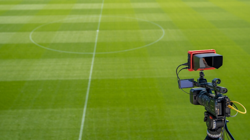 camera facing an empty football pitch
